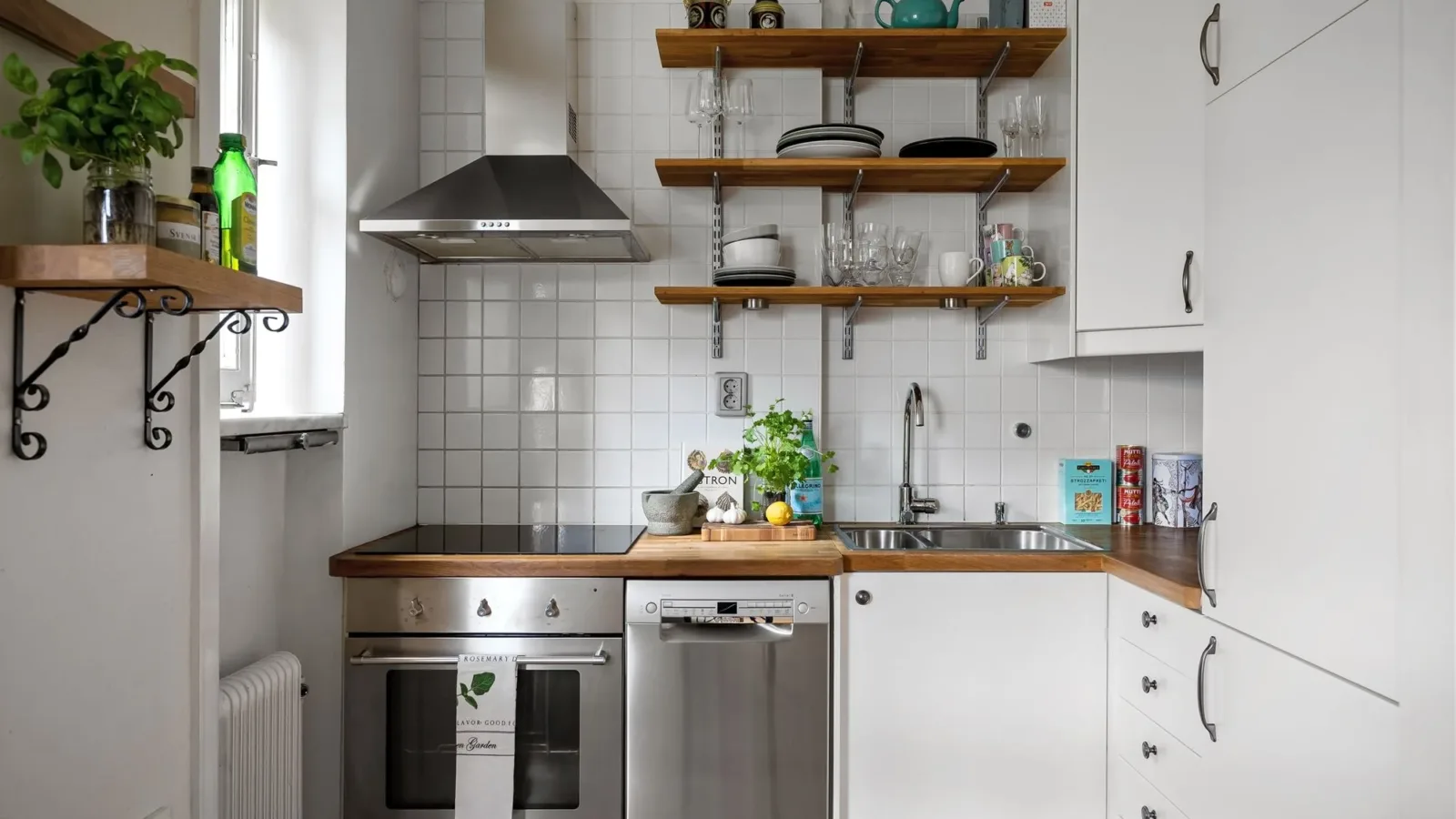 Contemporary small kitchen featuring stainless steel appliances and open shelving.